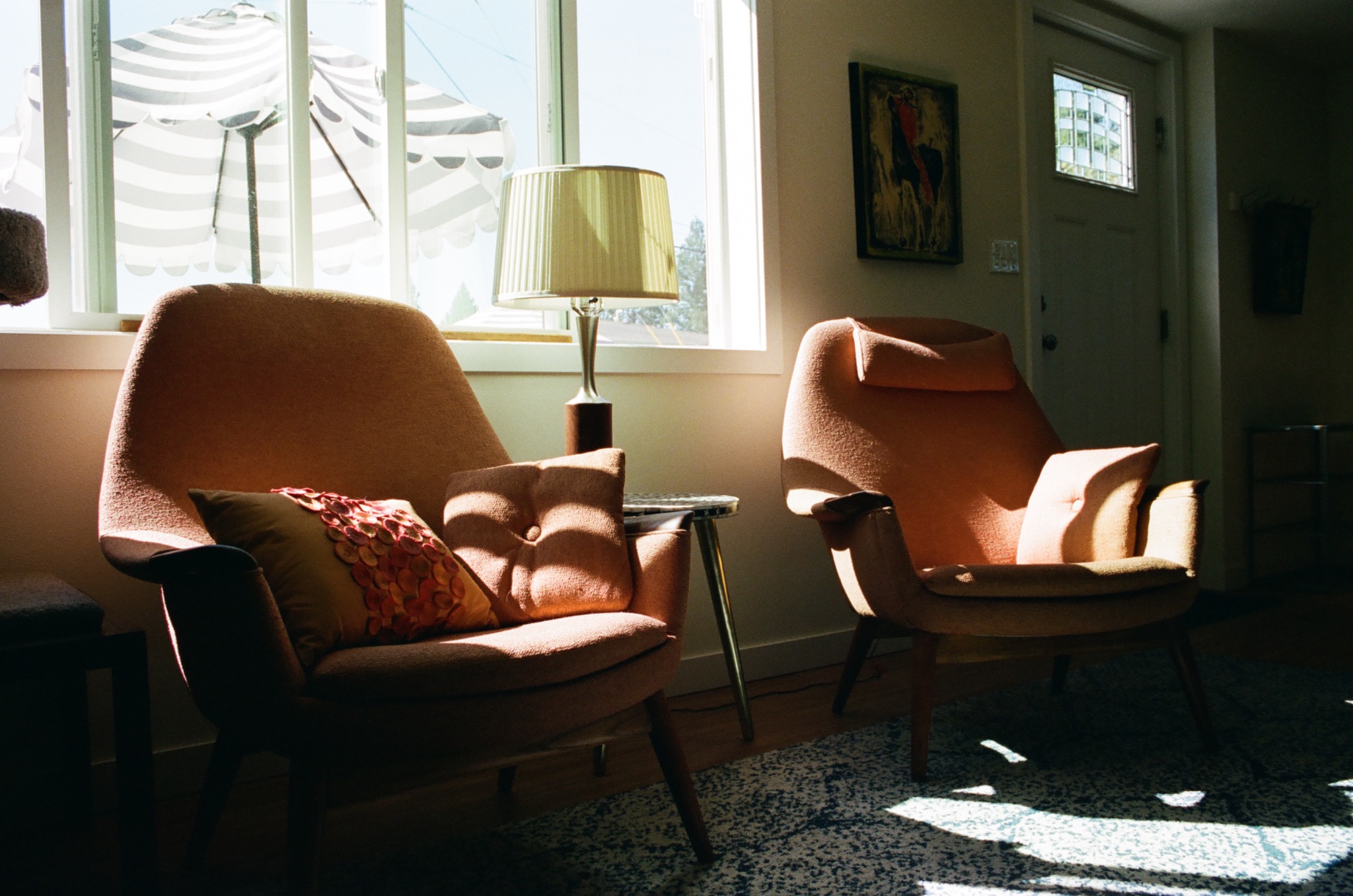 Two pink chairs in warm afternoon light
