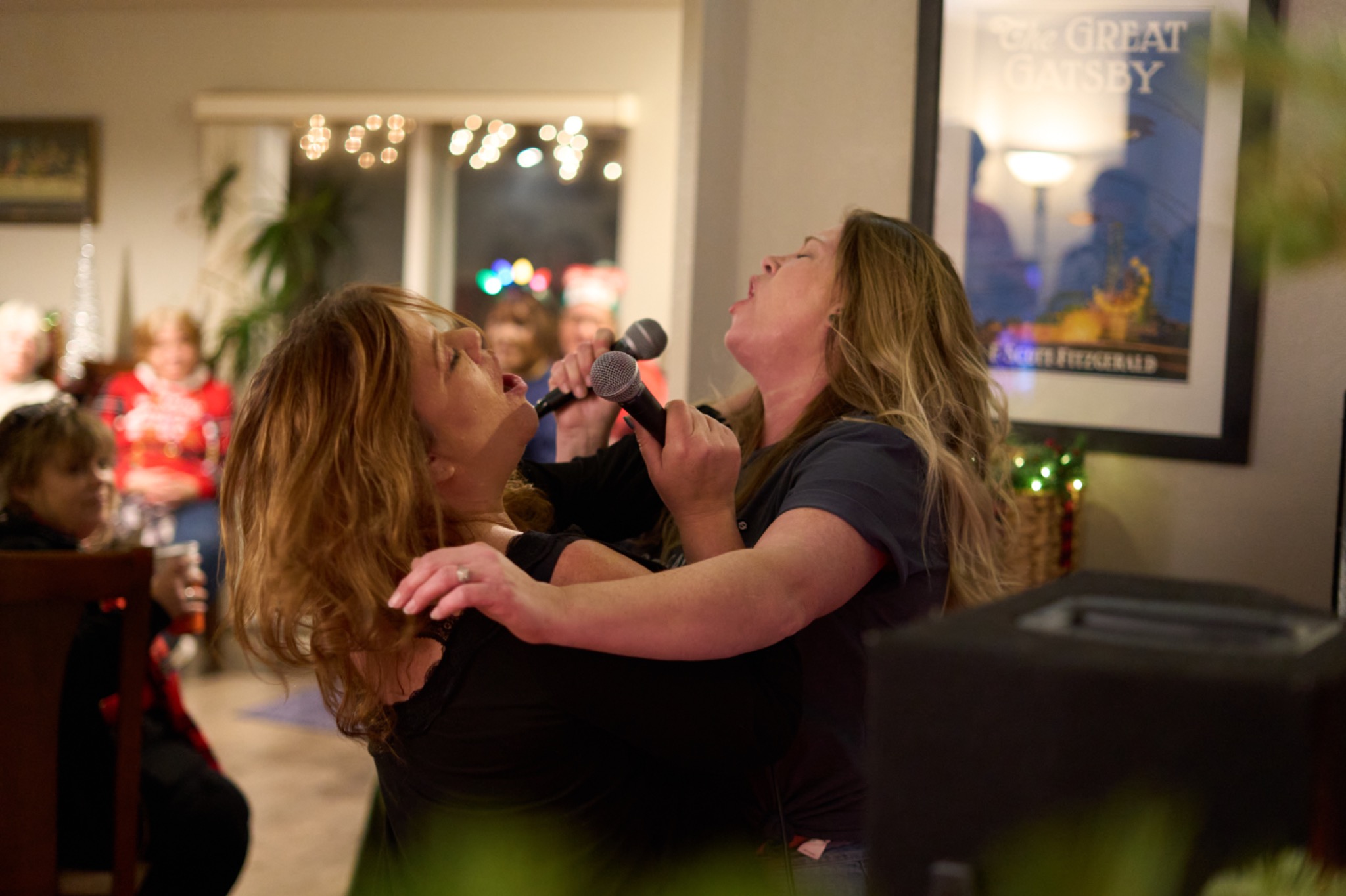 Two women singing karaoke together